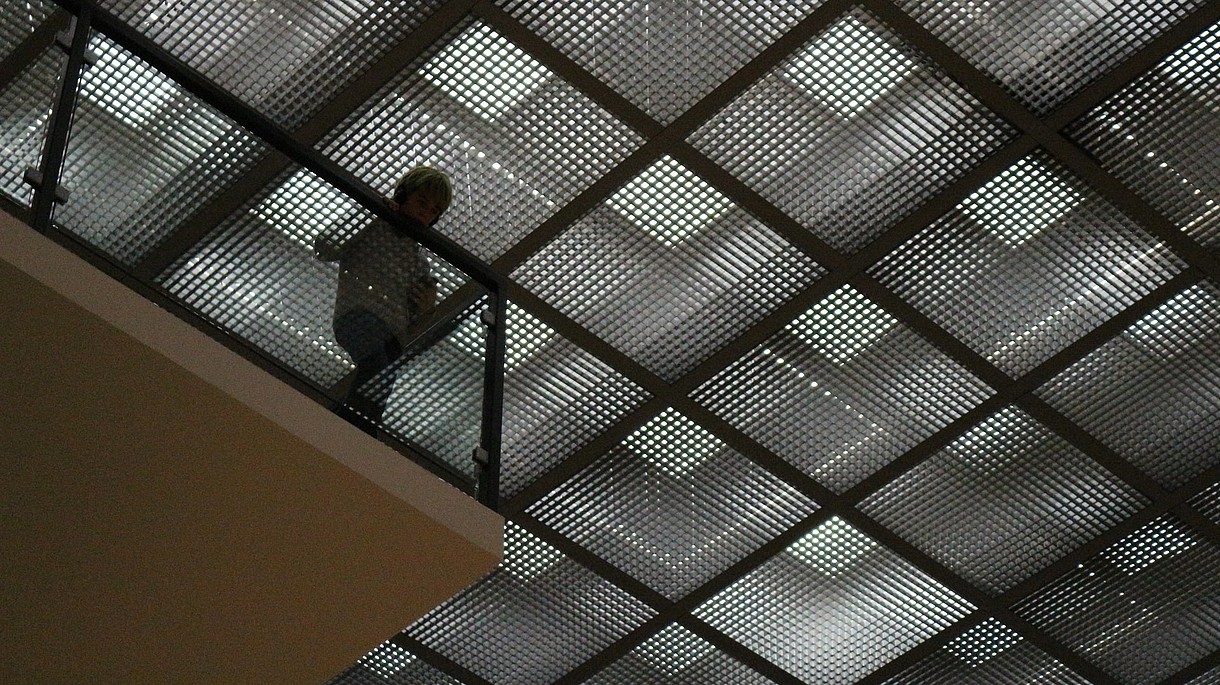  Child looks down through glass floor tiles. 
