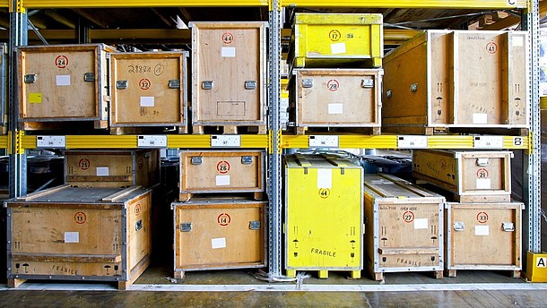  Wooden boxes are large shelves inside a depot.