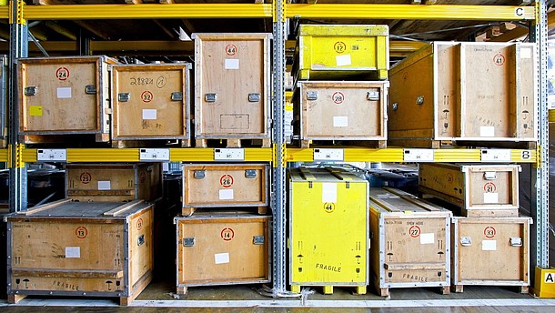  Wooden boxes are large shelves inside a depot.