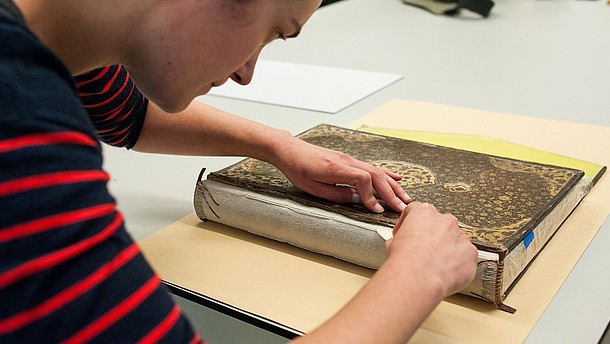  Closeup of someone doing restoration work on an old book. 